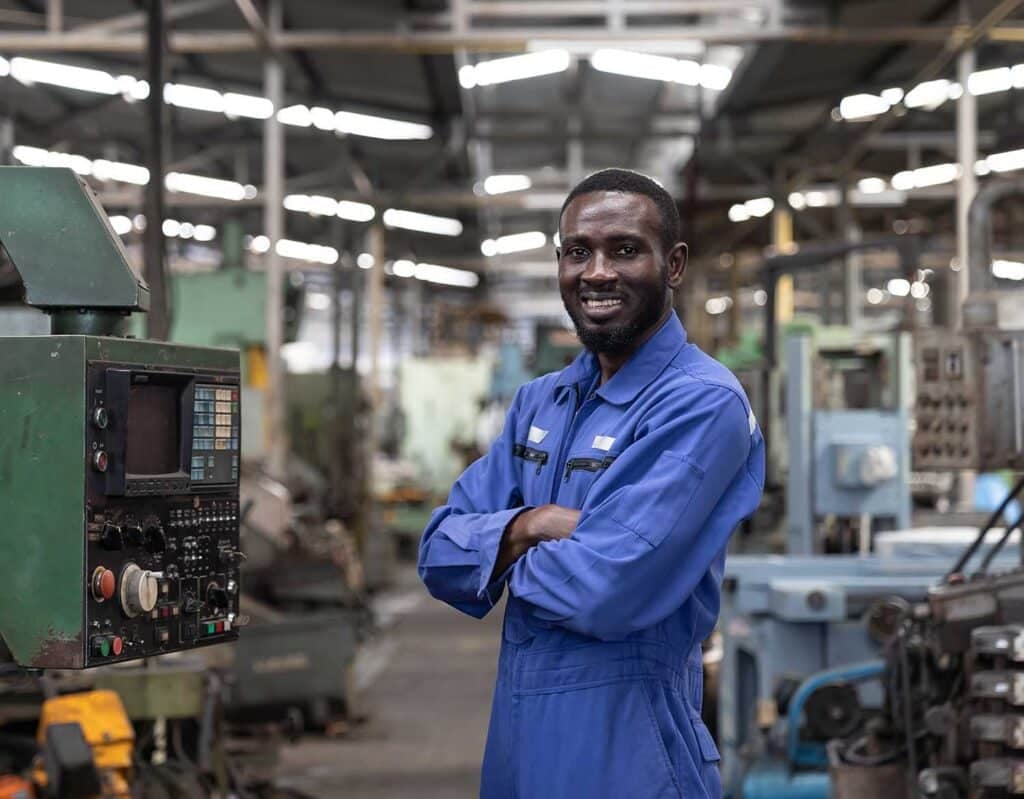 Portrait of smiling male engineer at work in the industry factory.